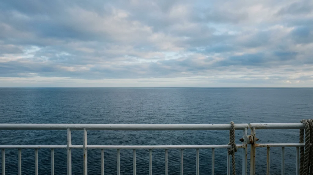 A calm sea horizon seen from a ferry deck.